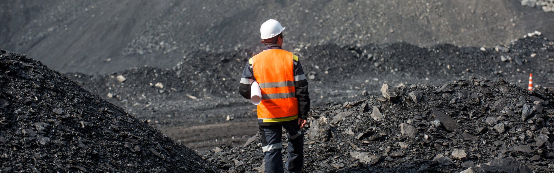 Worker is looking on the huge open pit
